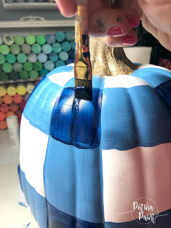 painting a buffalo check pumpkin