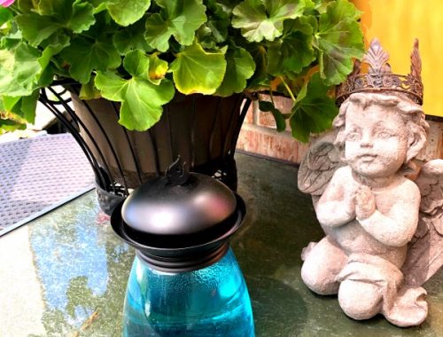 statue, geraniums, tiki lamp