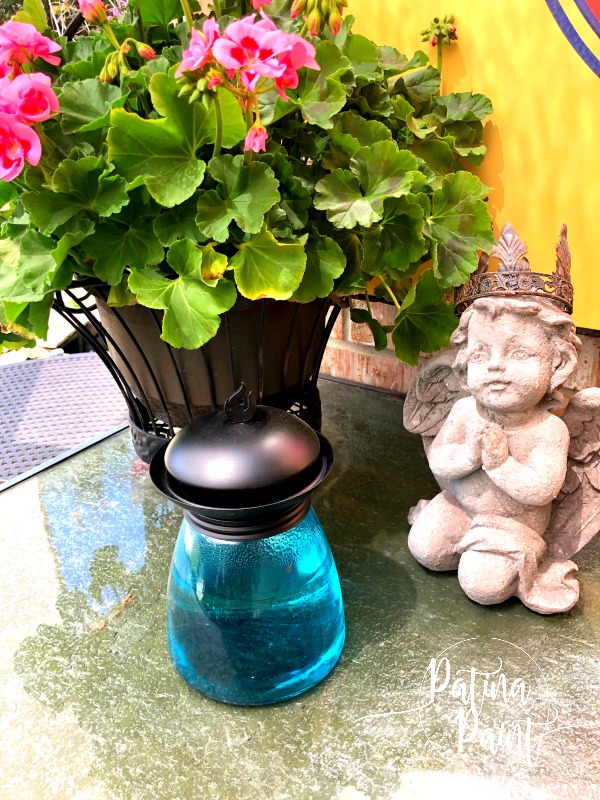 statue, geraniums, tiki lamp