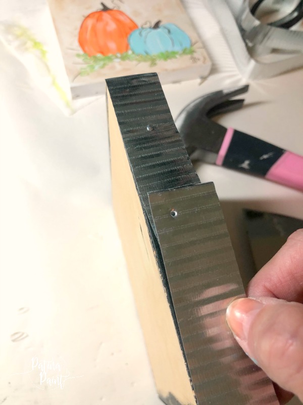 adding tin to a wooden painting