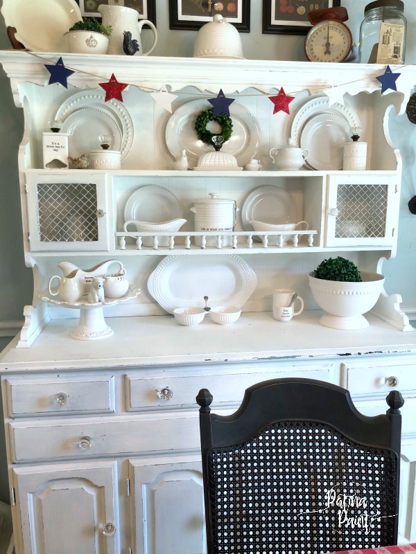 red white and blue banner, white kitchen hutch